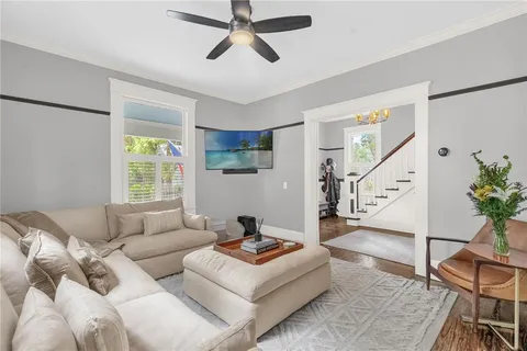 a living room with furniture and a potted plant