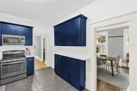 a kitchen with granite countertop wooden cabinets and stainless steel appliances