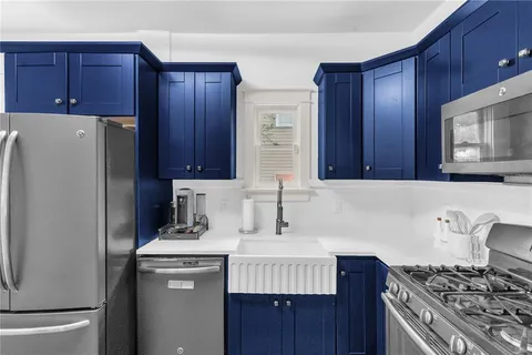 a kitchen with wooden cabinets and white appliances