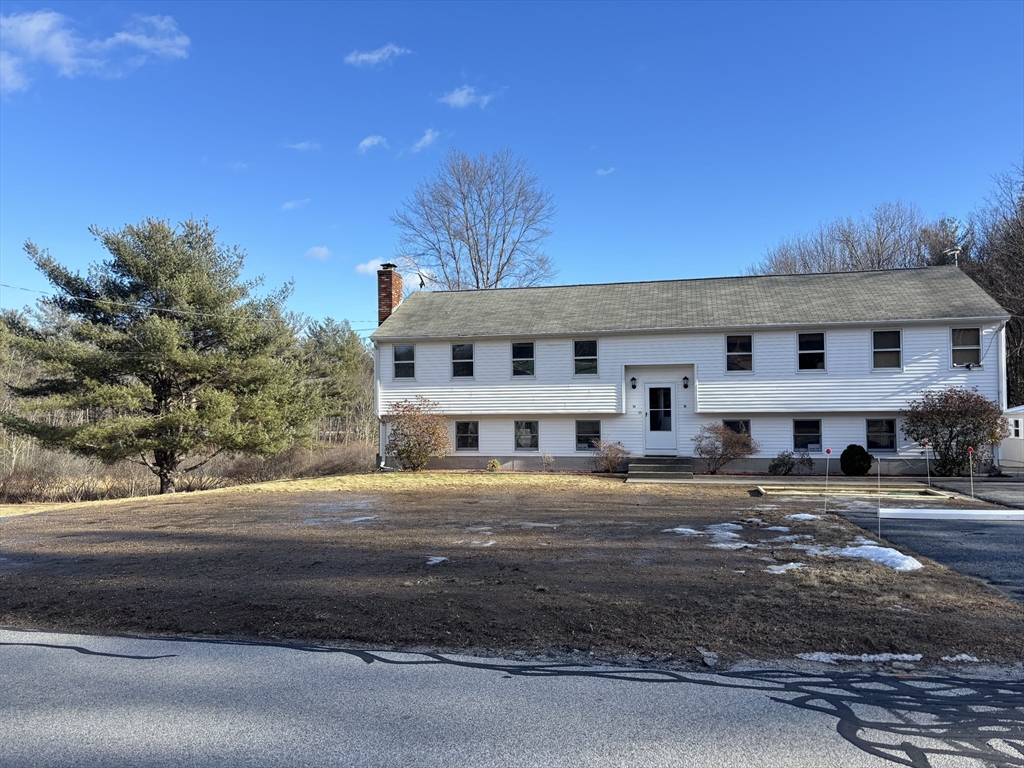 94 Monroe Street, Unit 2 Douglas, MA 01516 - Photo 1 of 10 a front view of residential houses with street