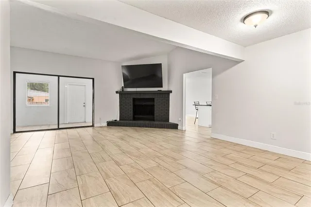 a view of empty room with a fireplace and cabinet