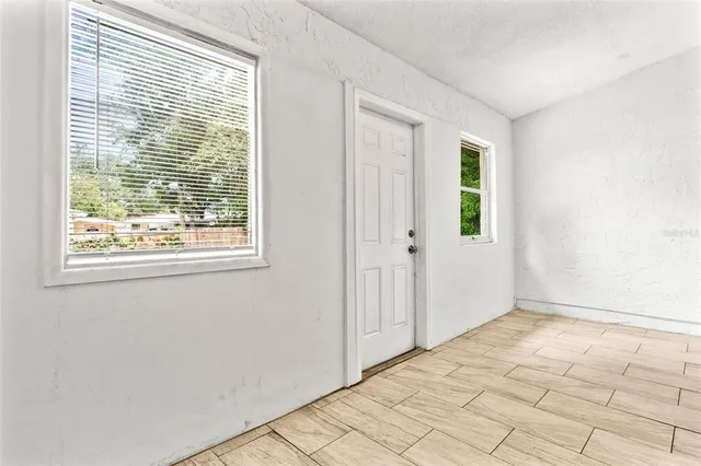 a view of an empty room with window and a window