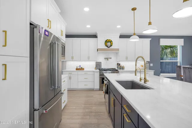 a kitchen with a sink stove and refrigerator