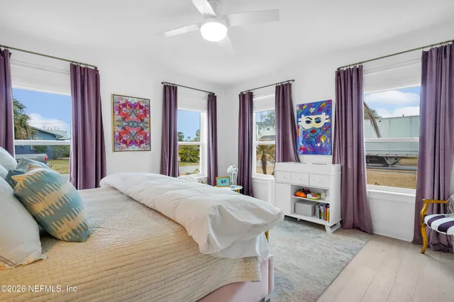 a bed sitting in a bedroom next to a window