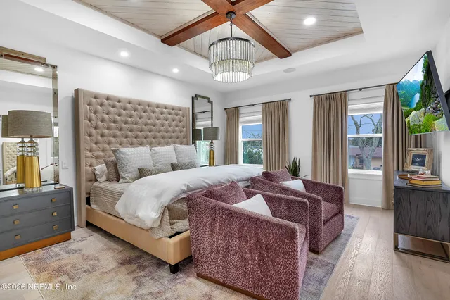 a bed room with a bed and a chandelier
