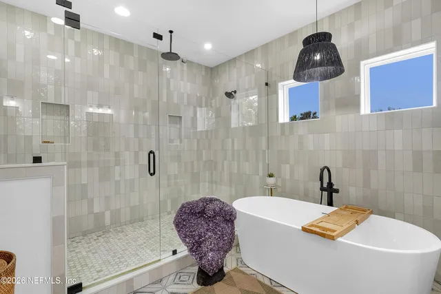 a spacious bathroom with double vanity sink a mirror and a shower