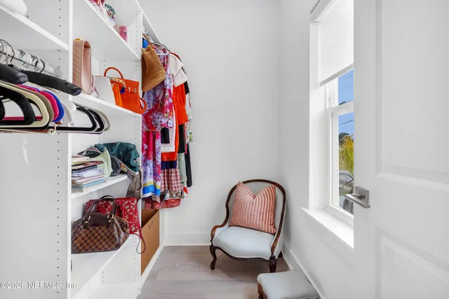 a spacious bathroom with a toilet sink and mirror