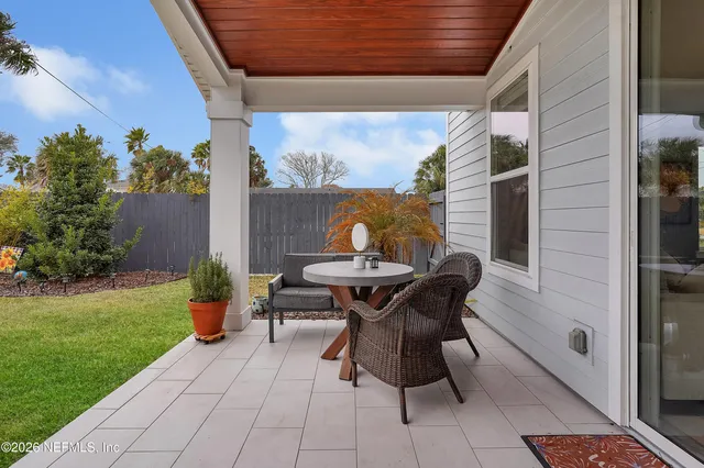 a view of a house with backyard and sitting area