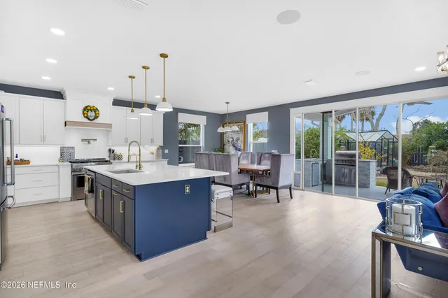 a kitchen with kitchen island granite countertop a sink and a stove