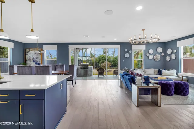a view of a dining room with furniture wooden floor and chandelier