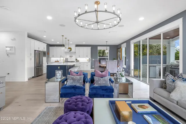 a living room with fireplace furniture and a large window
