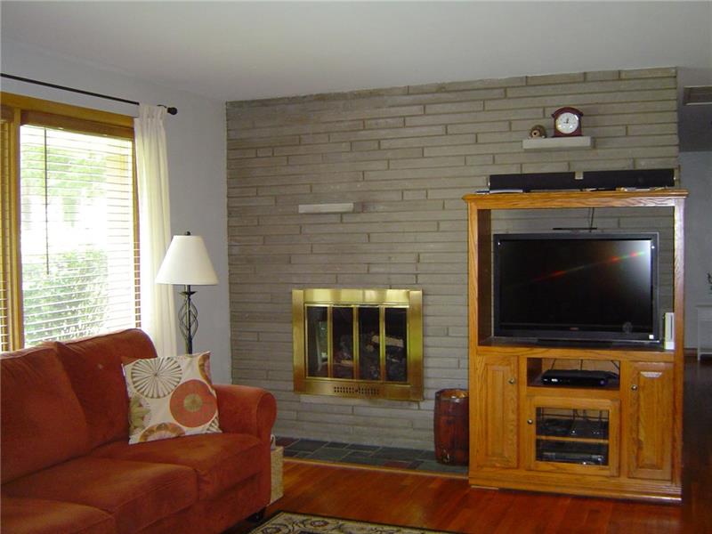 5055 Dutch Ridge Road Beaver, PA 15009 - Photo 4 of 20 Large living room has gas fireplace and bricked fireplace wall.