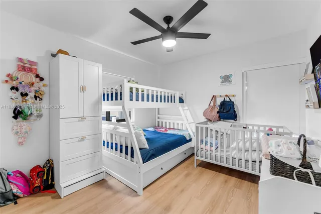 a bedroom with furniture and a large window