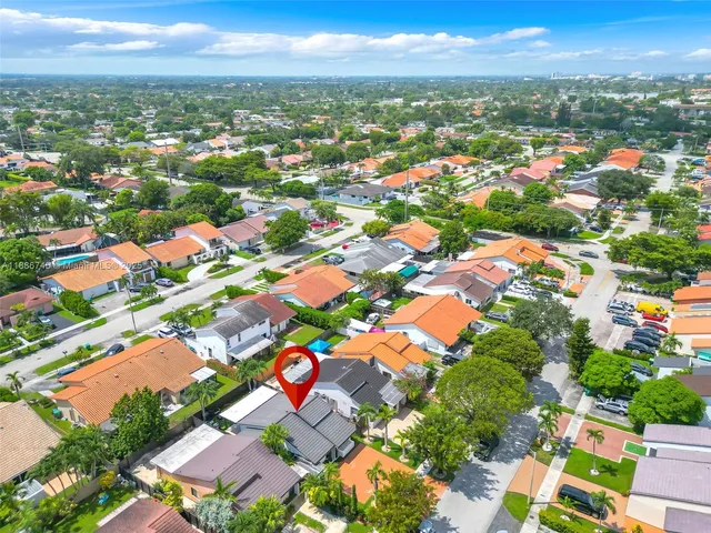 an aerial view of residential houses with outdoor space