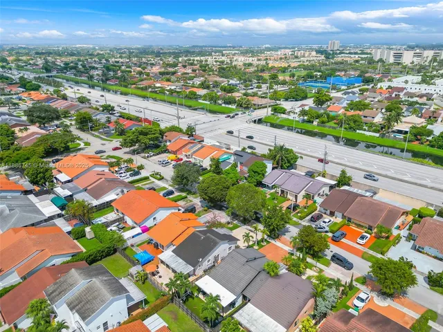 an aerial view of residential houses with outdoor space
