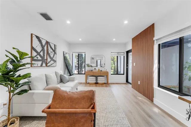 a living room with furniture and a potted plant