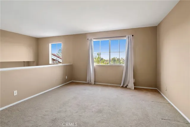 a view of an empty room and a window