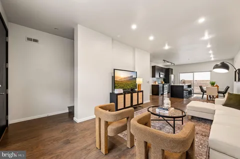 a living room with fireplace furniture and a wooden floor