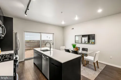 a kitchen that has a sink and a table in it