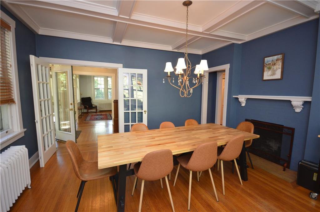 431 Locust Street Pittsburgh, PA 15218 - Photo 13 of 47 a view of a dining room with furniture wooden floor and chandelier