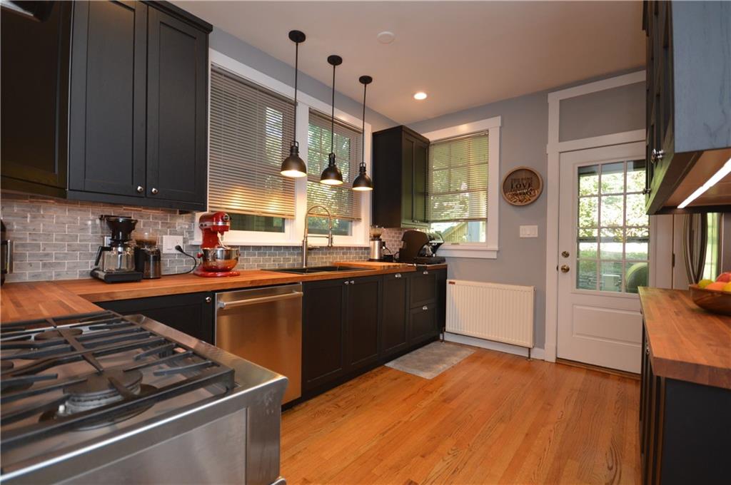 431 Locust Street Pittsburgh, PA 15218 - Photo 15 of 47 a kitchen with stainless steel appliances granite countertop a stove a sink and a refrigerator