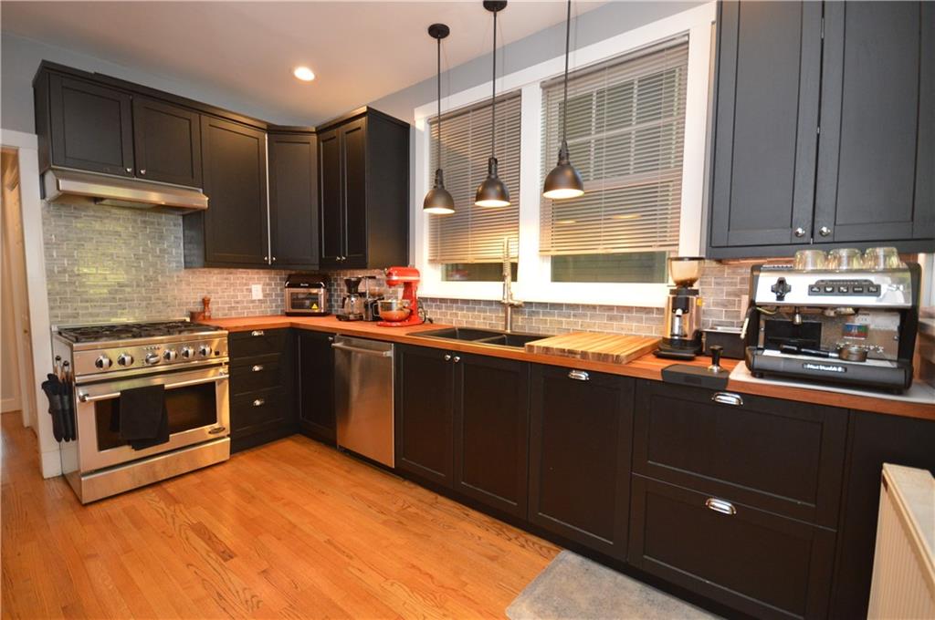 431 Locust Street Pittsburgh, PA 15218 - Photo 16 of 47 a kitchen with stainless steel appliances a sink stove and cabinets