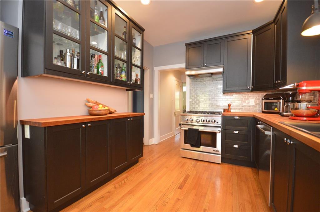 431 Locust Street Pittsburgh, PA 15218 - Photo 17 of 47 a kitchen with stainless steel appliances a stove and a refrigerator