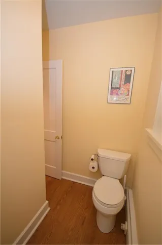 a white toilet sitting next to a white walls