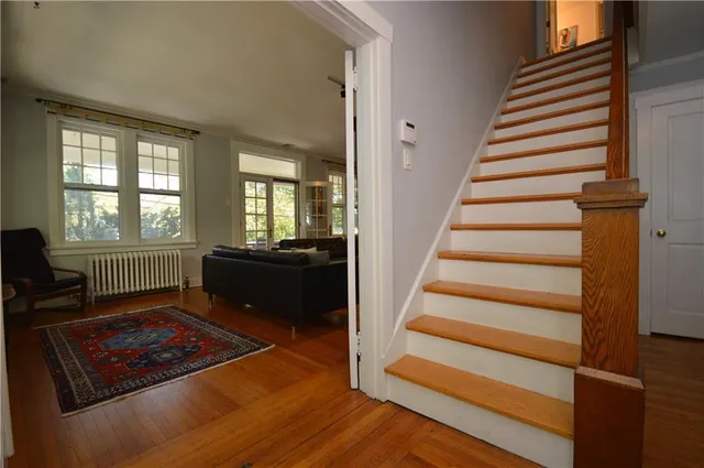a view of an entryway with wooden floor and a front door