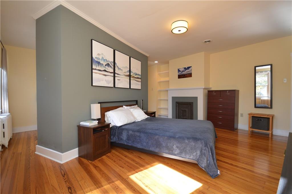 431 Locust Street Pittsburgh, PA 15218 - Photo 23 of 47 a bedroom with a bed and a fireplace