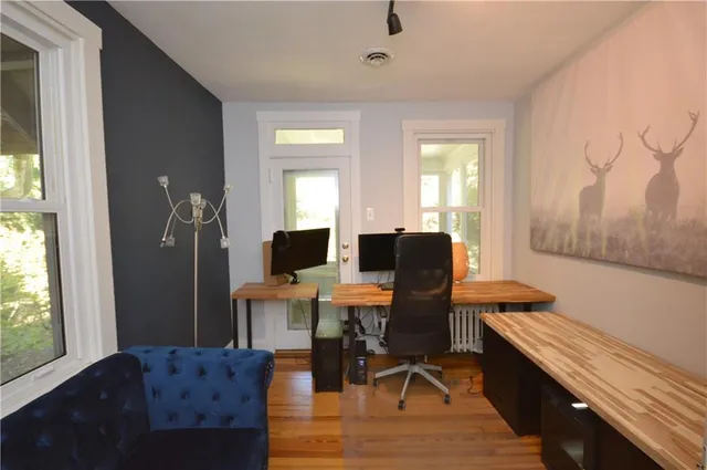 a view of a workspace with furniture and a window