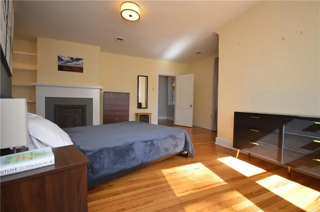 a spacious bedroom with a bed and a desk