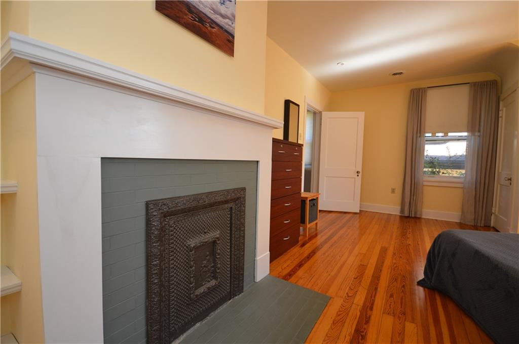 431 Locust Street Pittsburgh, PA 15218 - Photo 29 of 47 a view of a livingroom with wooden floor and a fireplace