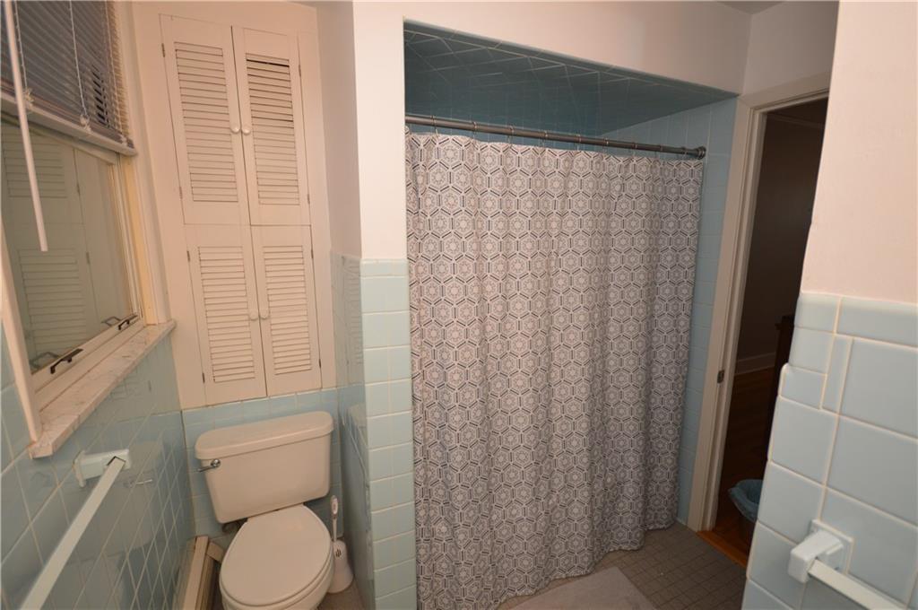 431 Locust Street Pittsburgh, PA 15218 - Photo 32 of 47 a white toilet sitting next to a shower curtain