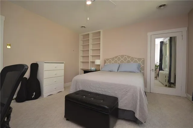 a bedroom with a bed and a window