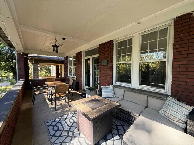 a living room with furniture and large windows