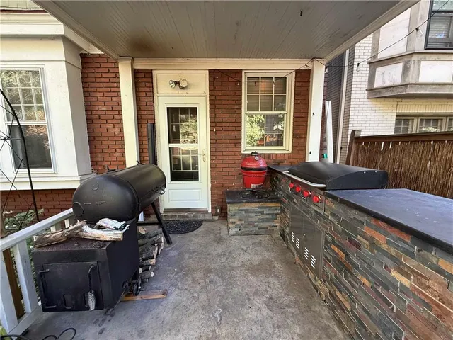 a view of a yard with plants and trees