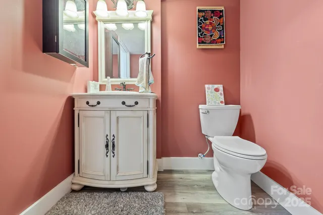 a bathroom with a toilet a sink and mirror