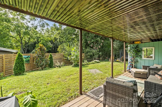 a view of backyard with swimming pool and outdoor seating