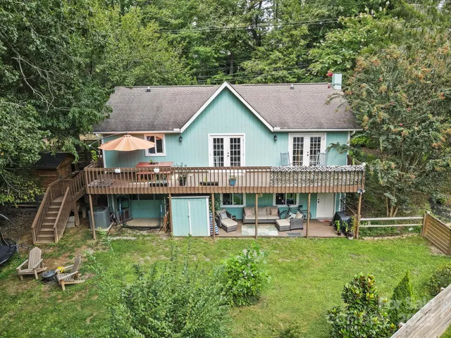 a view of a house with a yard and potted plants