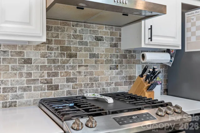 a stove top oven sitting inside of a kitchen