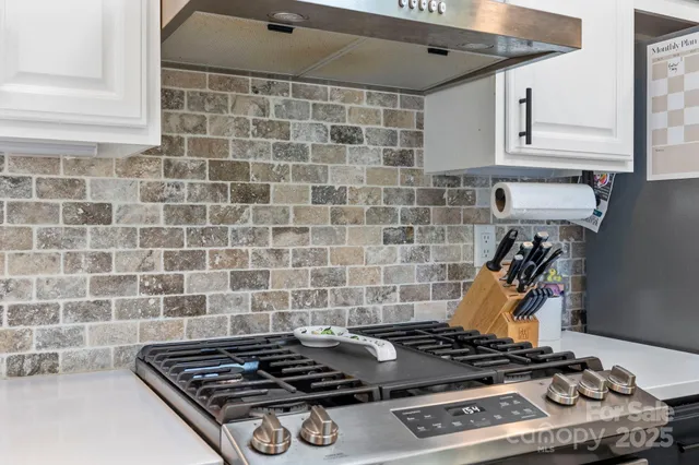 a stove top oven sitting inside of a kitchen