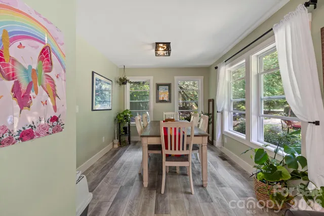 a dining room with furniture and wooden floor