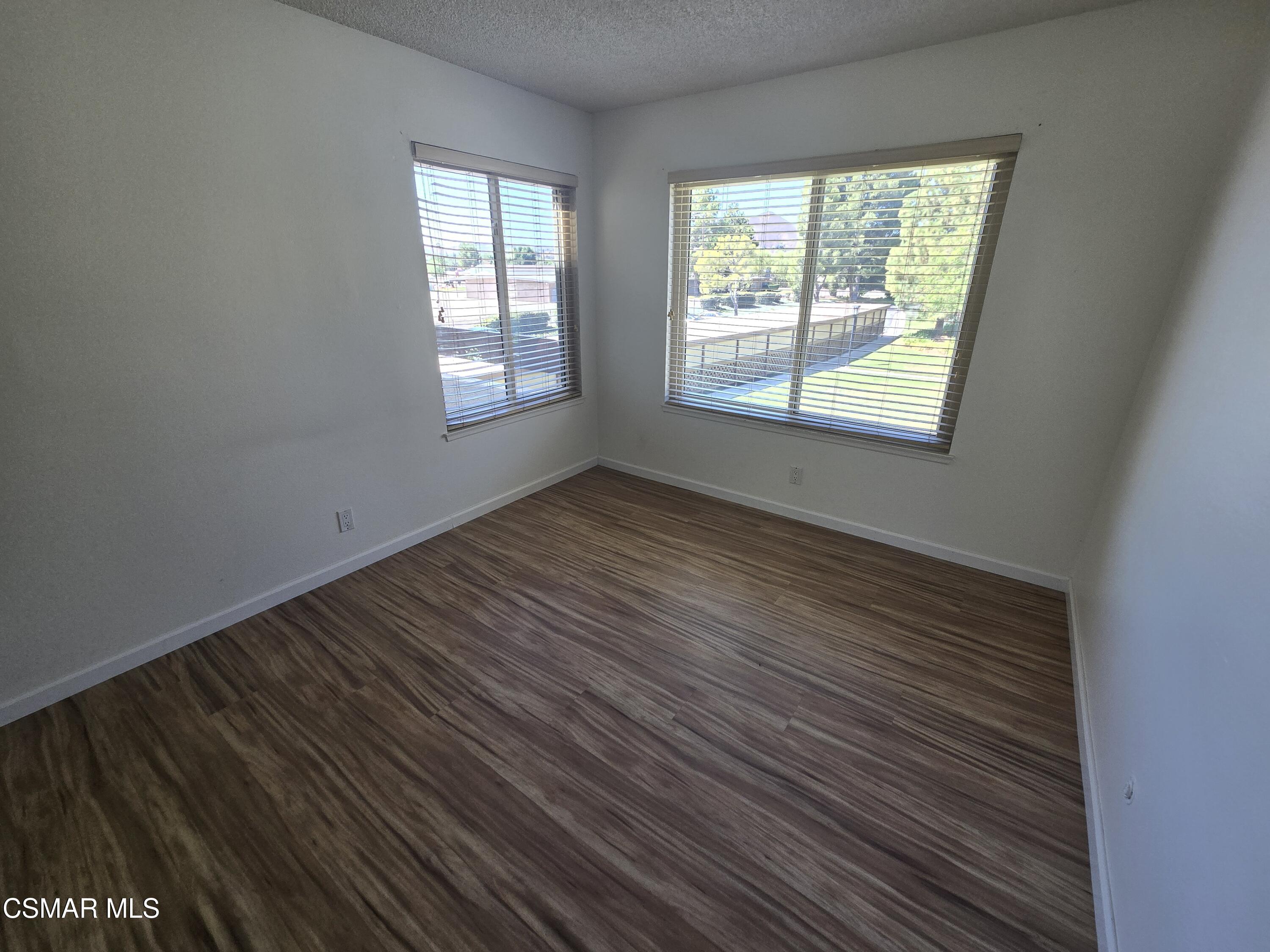 1778 Sinaloa Road, Unit 294 Simi Valley, CA 93065 - Photo 6 of 15 a view of an empty room with wooden floor and a window
