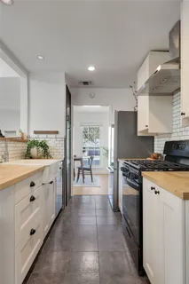 a kitchen with stainless steel appliances granite countertop a stove a sink and a refrigerator