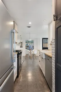 a large kitchen with lots of counter space and refrigerator