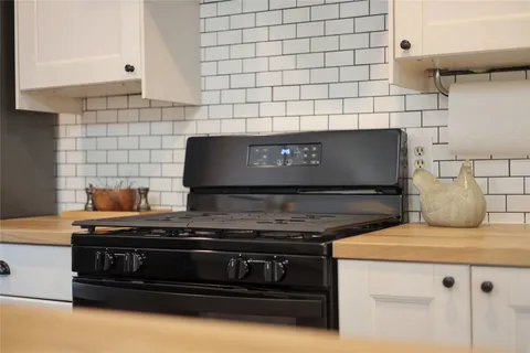 a stove top oven sitting inside of a kitchen