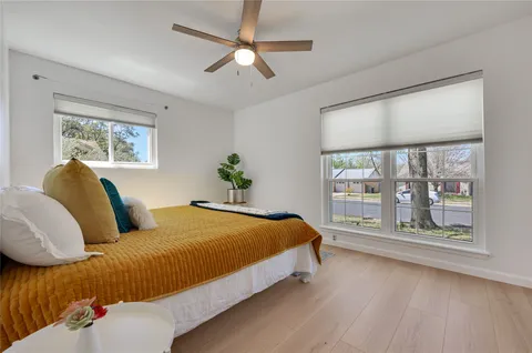 a bedroom with a large bed and a window