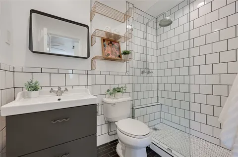 a bathroom with a sink mirror and toilet