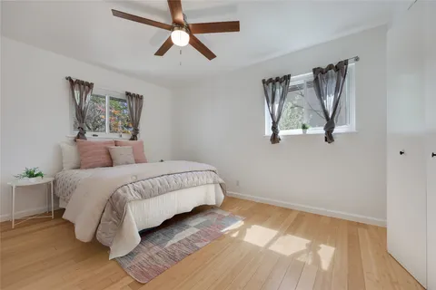 a bedroom with a bed and a painting on the wall